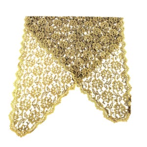 May include: Gold-colored lace fabric with a floral pattern. The lace is folded over, creating a layered effect. The edges are scalloped, adding a decorative touch. The fabric is likely used for crafting or embellishment.
