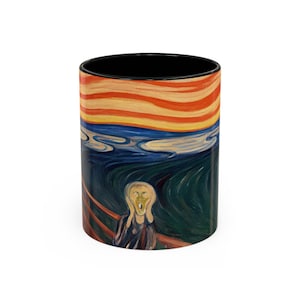May include: A black coffee mug featuring a colourful image of Edvard Munch's "The Scream" painting. The painting depicts a figure with a distorted face against a swirling background of red, orange, yellow, blue and green.