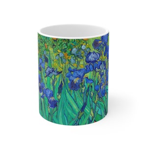 May include: A white ceramic mug featuring a colourful image of blue irises and green leaves. The image is a reproduction of a famous painting.