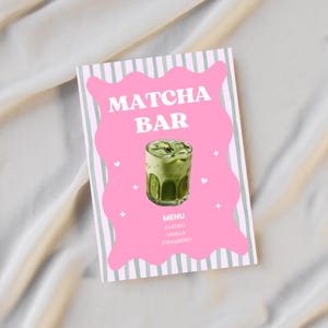 May include: A pink and green menu for a Matcha Bar. The menu features a glass of matcha drink with ice cubes. The text "Matcha Bar" is at the top, with "Menu" and drink flavors listed below.