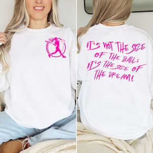 May include: White sweatshirt with a pink graphic of a softball player on the front and the text "It's not the size of the ball, it's the size of the dream!" on the back.