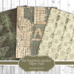 May include: A paper pack with three sheets of decorative paper. The sheets have a vintage aesthetic with botanical and text-based designs in shades of green, brown, and cream. The text "The forgotten Garden Paper Pack" is visible.