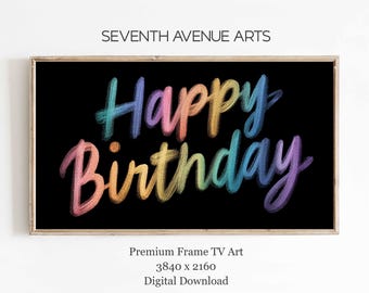 May include: A framed digital art print with the words "Happy Birthday" in colorful, rainbow-colored script on a black background. The text is in a handwritten style. The frame is a light brown color. The words "Seventh Avenue Arts" are at the top.