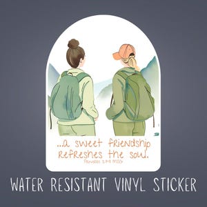 May include: Water-resistant vinyl sticker featuring an illustration of two people with backpacks, facing away, in a mountain scene. The sticker has the text "...a sweet friendship refreshes the soul." and "WATER RESISTANT VINYL STICKER".