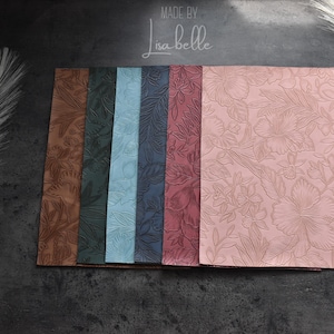 May include: Six different colours of embossed floral patterned paper. The colours are brown, dark green, light blue, dark blue, burgundy, and pink. The paper is made by Lisa Belle.