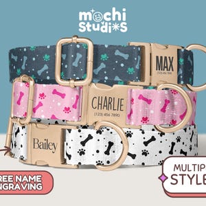 May include: Three personalized dog collars with gold-colored hardware. The collars feature patterns of bones and paw prints in various colors, including navy, pink, and white. Each collar has a name and phone number engraved on the buckle.