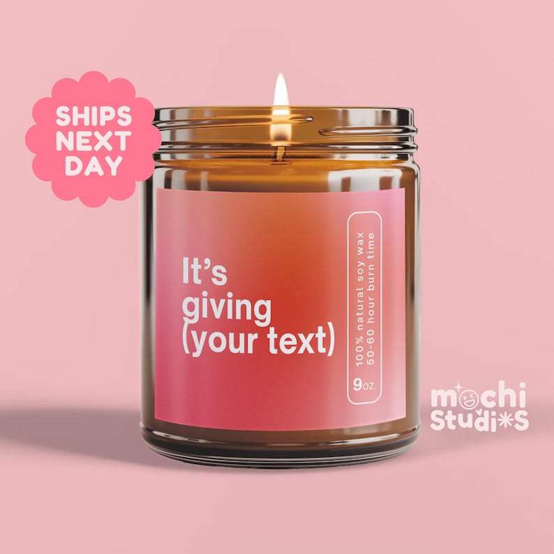 a brown glass jar candle with a pink label