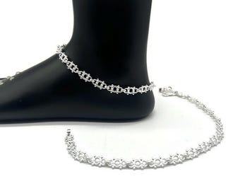 May include: Two silver anklets with a delicate, circular chain design. The anklets are laid out on a white background.