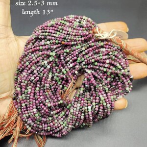 May include: A strand of green and pink gemstone beads, approximately 2.5-3 mm in size, with a total length of 13 inches. The beads are round and have a smooth, polished finish.