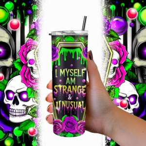 May include: A black and green stainless steel tumbler with a skull and rose design. The tumbler has the text "I Myself Am Strange & Unusual" printed on it.