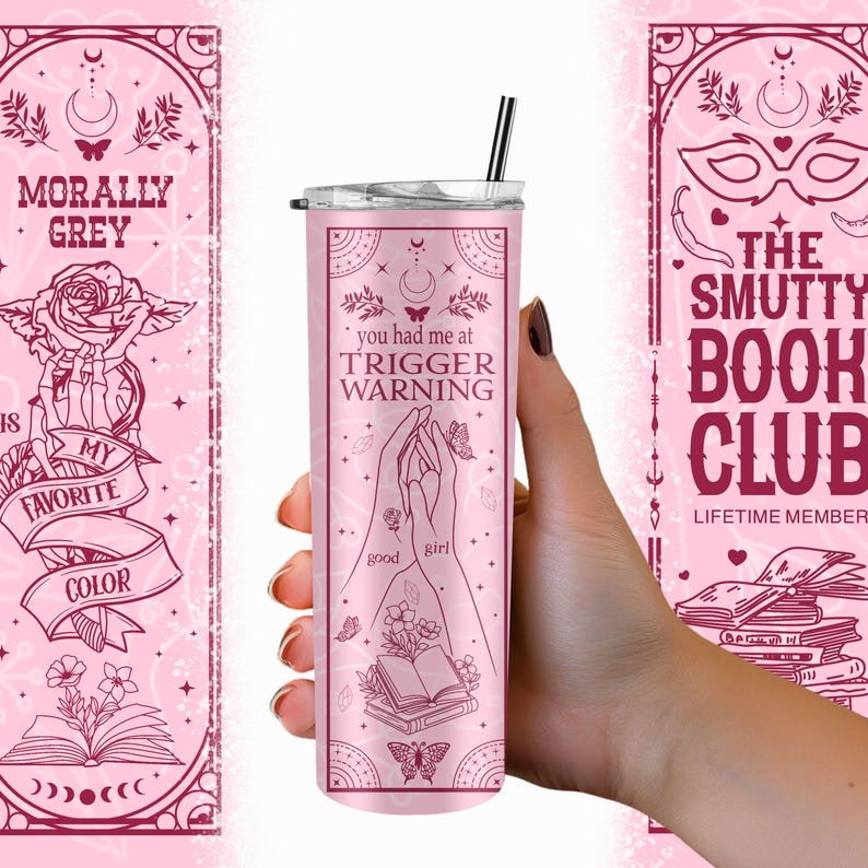 May include: Pink stainless steel tumbler with a black lid and straw. The tumbler features a graphic design with a book, butterflies, and the text "you had me at trigger warning good girl".