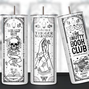 May include: Three white tumblers with black designs. The first tumbler says "Morally Grey" with a skull and crossbones and the text "My Favorite Color". The second tumbler says "You had me at Trigger Warning" with a pair of hands holding a book. The third tumbler says "The Smutty Book Club" with a mask and a stack of books.