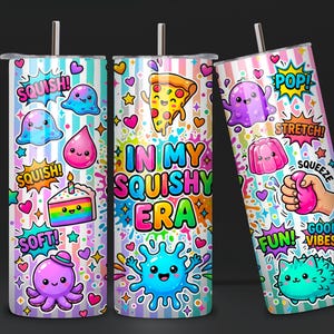 May include: Three cylindrical tumblers with straws featuring a pastel striped background and colorful cartoon graphics including a pizza slice, octopus, cake, and slime. The text reads "IN MY SQUISHY ERA" along with "SQUISH!", "POP!", "STRETCH!", "SQUEEZE", "SOFT!", "FUN!", and "GOOD VIBES!"