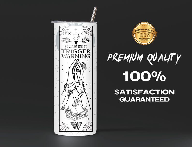 May include: White stainless steel tumbler with a black and white design featuring two hands holding a book with the text "you had me at TRIGGER WARNING".