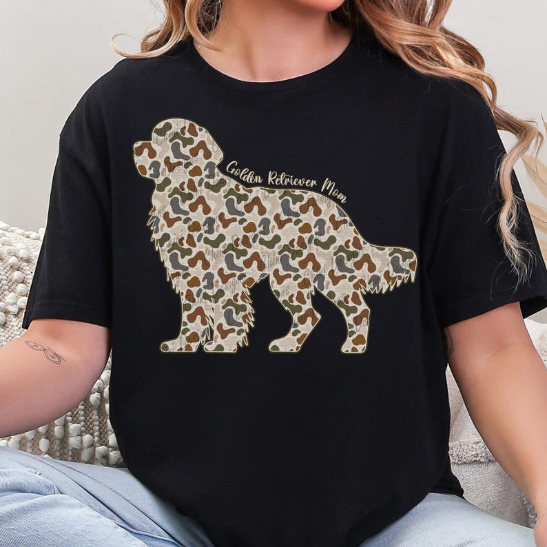 A woman wearing a black t-shirt with a camouflage pattern of a dog silhouette.