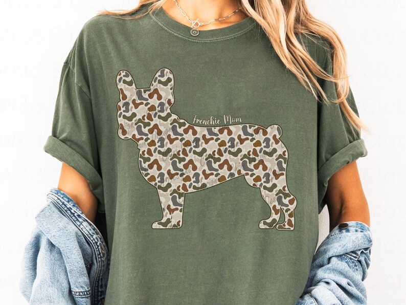 A woman wearing a green t-shirt with a camouflage print of a dog.