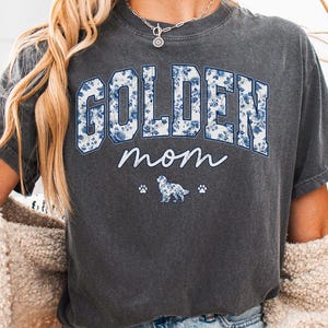 a woman wearing a golden mom t - shirt