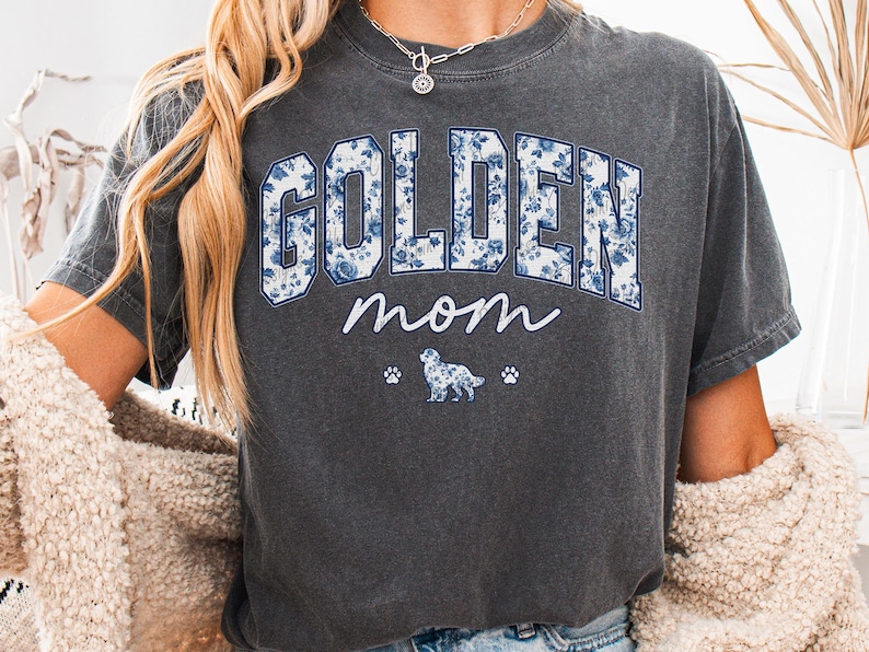 a woman wearing a golden mom t - shirt