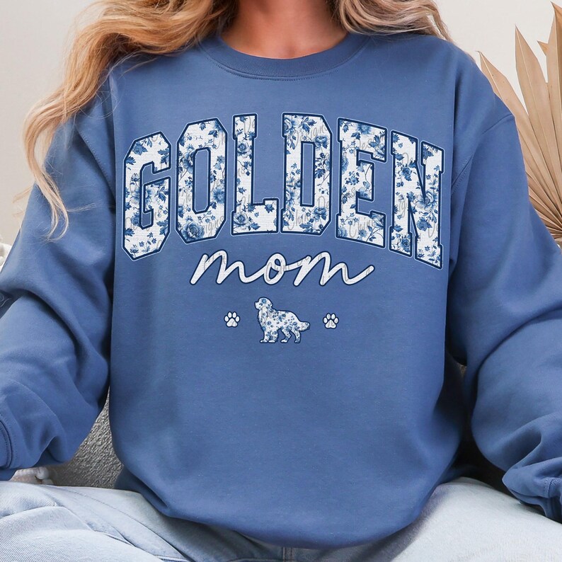 a woman wearing a sweatshirt that says golden mom