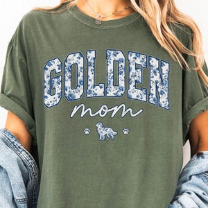 a woman wearing a green shirt that says golden mom