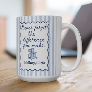 May include: White ceramic mug with a blue and white striped pattern. The mug features a blue framed design with the text "Never forget the difference you make" and the name "Mallory, CRNA".