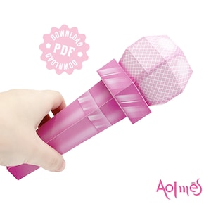 May include: A pink paper microphone with a geometric design on the head and handle. The microphone is held in a hand. A pink circle with the text "DOWNLOAD PDF" is in the upper left corner.