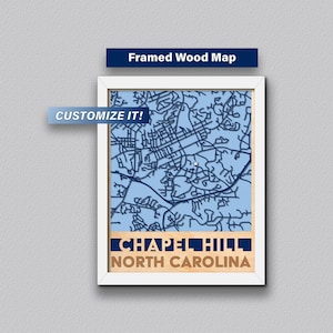 May include: Framed wood map of Chapel Hill, North Carolina. The map is blue and white with a white frame. The text "CUSTOMIZE IT!" is in a white box in the upper left corner.
