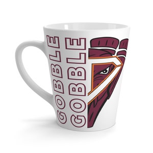 May include: White ceramic latte mug with a maroon and orange graphic of a bird's head and the word "GOBBLE" repeated vertically on the side.