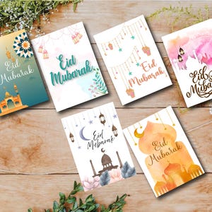 May include: Six different greeting cards with watercolor designs and the text "Eid Mubarak" in various styles. The cards feature a variety of colors, including pink, blue, green, and orange.