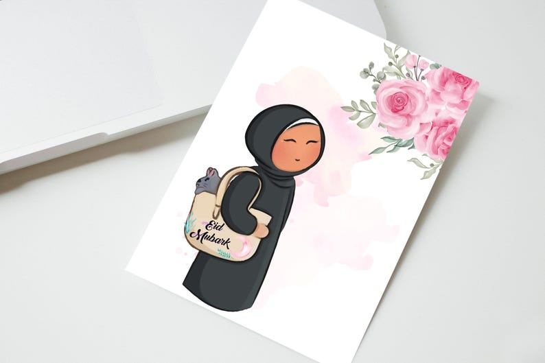 May include: A cartoon illustration of a person wearing a black hijab and carrying a beige tote bag with the text "Eid Mubarak" on it. The bag has a pink floral design and a gray cat peeking out of the top. The background is a watercolor wash of pink and white.
