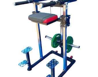 May include: A black and blue weight training machine with a gray and red padded seat, black handles, and footrests. Green weight plates are attached to a bar. The machine is designed for exercise and strength training.