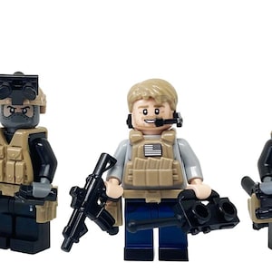 May include: Three custom action minifigures from Brick Unit. Each figure is dressed in tactical gear, including vests and helmets. One figure holds a tan shotgun, another a black rifle, and the third a black sniper rifle. The figures are on a white background.