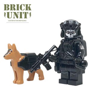 May include: A black action figure of a soldier with a skull mask, holding a black rifle, and a tan and black dog. The figure has a backpack and helmet. The text "BRICK UNIT" and "CUSTOM ACTION MINIFIGURES" is at the top.