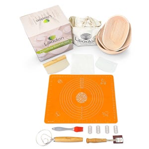 May include: A bread proofing basket set by Liliadon including a cardboard box, a beige fabric bag, two oval rattan baskets, a wooden dough scraper, a plastic scraper, a square orange silicone mat, a metal whisk, a red silicone brush, and four blades.