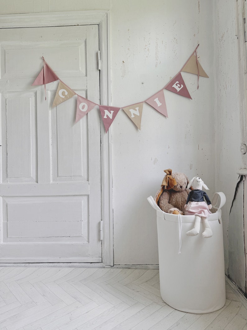 Custom cotton fabric bunting banner with individual name on garland text phrase triangles Connie girl for bedrrom 1st birthday party celebration girlande banderole wimpelkette made to order reusable white letters bedroom bed gift idea newborn shower