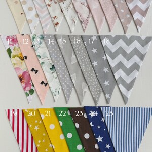May include: A set of 25 fabric pennants with various patterns, including polka dots, stars, stripes, and floral designs. The pennants are numbered 1 through 25.