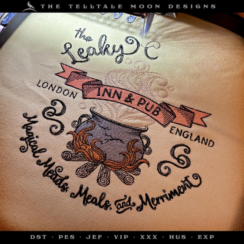 May include: Embroidered design of the Leaky Cauldron Inn & Pub in London, England. The design features a cauldron over a fire, with the text "Magical Meads, Meals, and Merriment".
