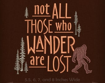 May include: Embroidered design with the text "not ALL THOSE who WANDER are LOST" in a brown and orange color scheme. The design also includes a stylized image of a Bigfoot and pine trees. The design is available in sizes 5.5, 6, 7, and 8 inches wide.