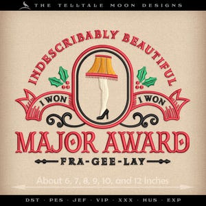 May include: Embroidered design featuring a red and white lampshade with legs, surrounded by a red and green wreath with the text "Indescribably Beautiful" and "I Won" on either side. The text "Major Award" is below the lampshade with the text "Fra-Gee-Lay" underneath. The design is available in sizes from 6 to 12 inches.