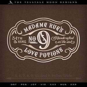 May include: White embroidered design on a brown background. The design is a circular frame with the text "Madame Rue's No. 9 Love Potions" and "34th & Vine Handcrafted in the sink". The design is 9, 10, and 11 inches wide.