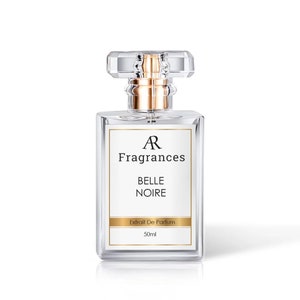 May include: A rectangular perfume bottle made of clear glass, featuring a crystal-cut stopper and gold detailing. The label displays "AR Fragrances BELLE NOIRE Extrait De Parfum 50ml."
