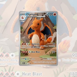 May include: A Charizard trading card featuring a knitted orange dragon-like creature with blue wings and a cream-colored belly. The card displays 220 HP, the attacks Incinerate and Heat Blast, and text describing the creature's flight altitude.