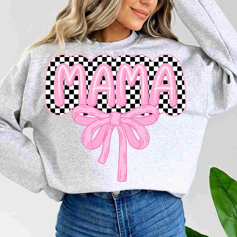 May include: A gray sweatshirt with a pink checkered design that says "MAMA" in pink letters with a pink bow underneath.