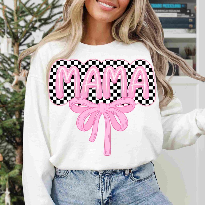 May include: White sweatshirt with a pink checkered "MAMA" graphic and a pink bow.