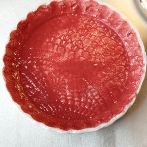 ring sizer, round earthenware pocket emptier with red lace