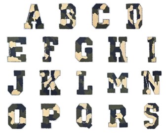 May include: A set of 26 iron-on letters in a camouflage pattern. The letters are in uppercase and are arranged in alphabetical order. The letters are a dark green, light green, and tan color.