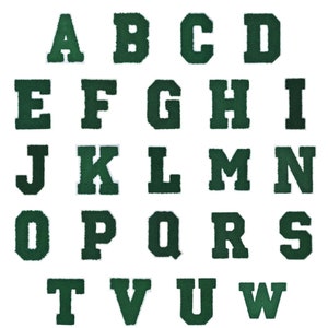May include: A set of 26 green felt letter patches, each with a white outline. The letters are in uppercase and are arranged in alphabetical order.