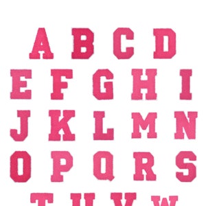 May include: Pink felt letters of the alphabet, A through Z, in a block font style.