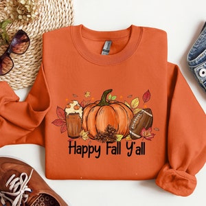 May include: Orange sweatshirt with a pumpkin, a glass of beer, and a football with the text "Happy Fall Y'all".