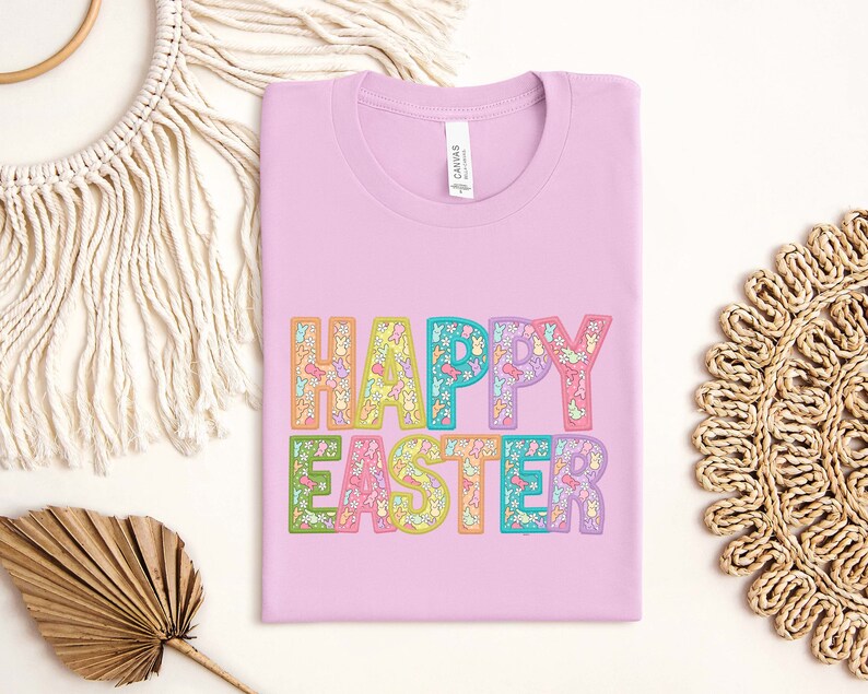 May include: A pink t-shirt with the text "HAPPY EASTER" in rainbow colors. The letters are filled with small Easter-themed illustrations.